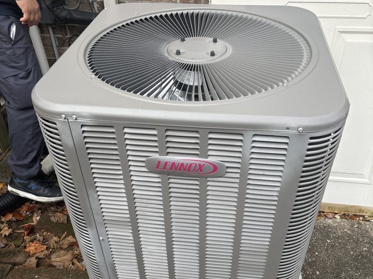 Lennox outdoor unit with a technician working beside it