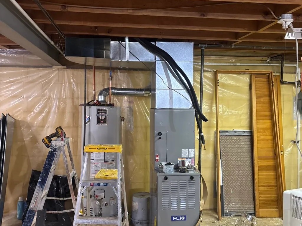 Furnace and water heater in a basement during an installation