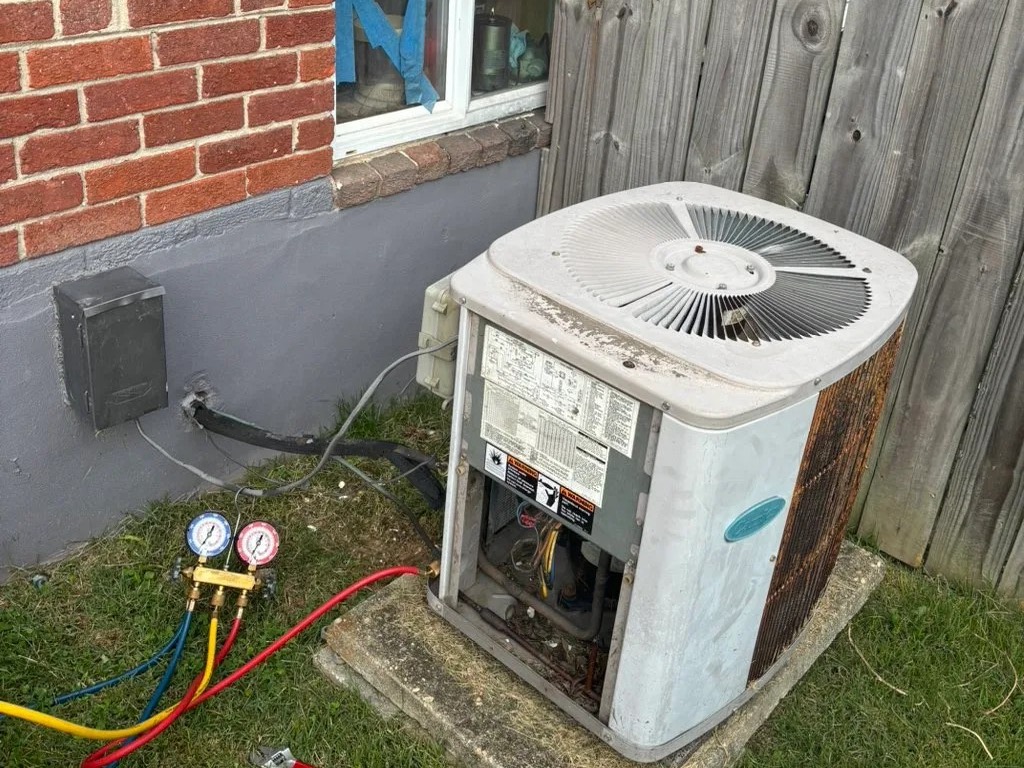 Condenser opened up for service with manifold gauges attached